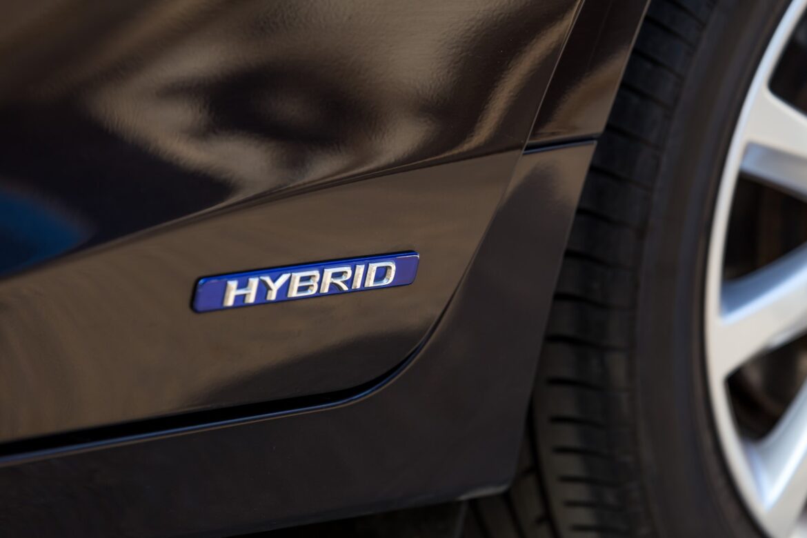Close up of a logo of Hybrid technology on the car's door representing the car is equipped with the Hybrid technology