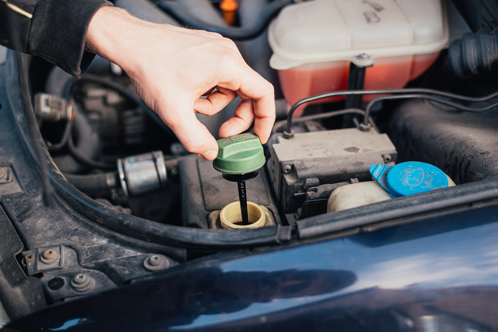 Mechanic tightened the valve Brake fluid reservoir. Car mechanic exchanges brake system fluid.