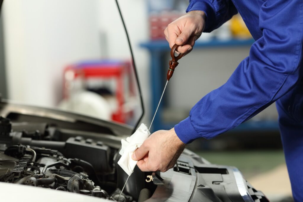 Car service professional checking the fluid levels in the car