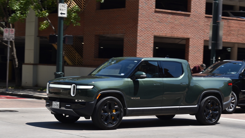 A Rivian R1T speeding in the downtown financial district. What an excite inspiring pick-up truck.
