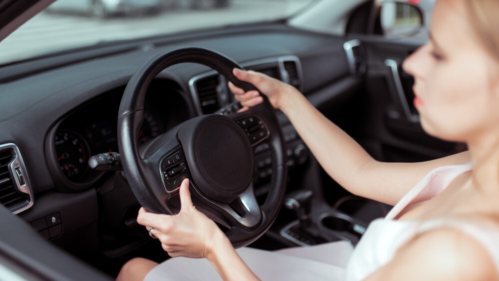 Young women holding the steering wheel 