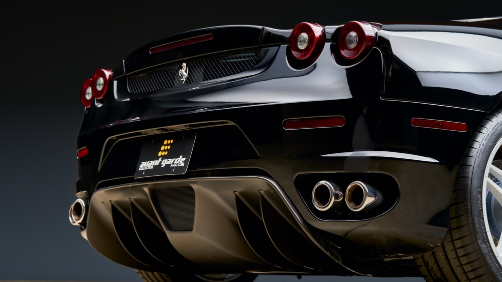 Black Ferrari 430 parked showing the exhaust of the car