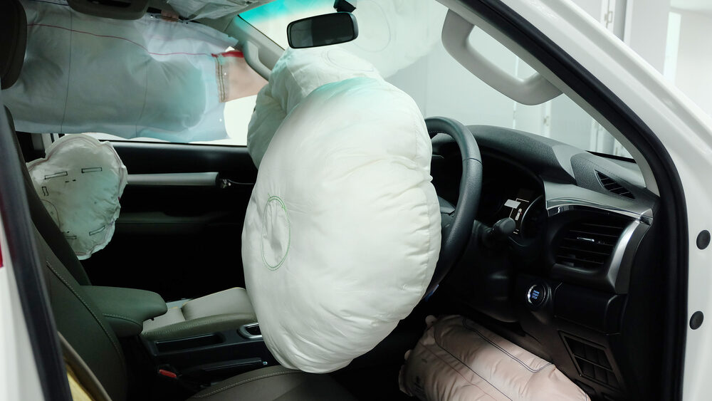Inside of car with all airbags opened up representing the safety of cars